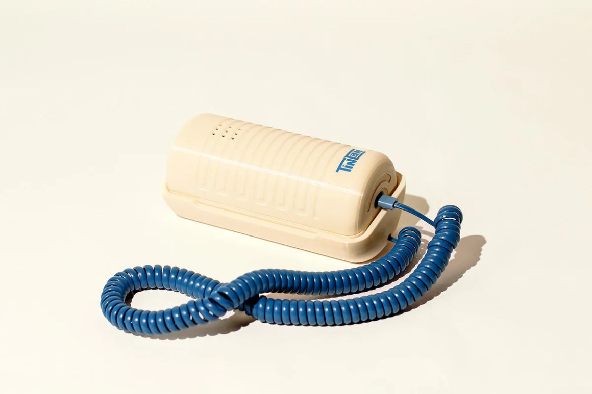 A beige retro landline phone called 'Tin Can' with a blue coiled cord, designed to evoke nostalgia for simpler communication.