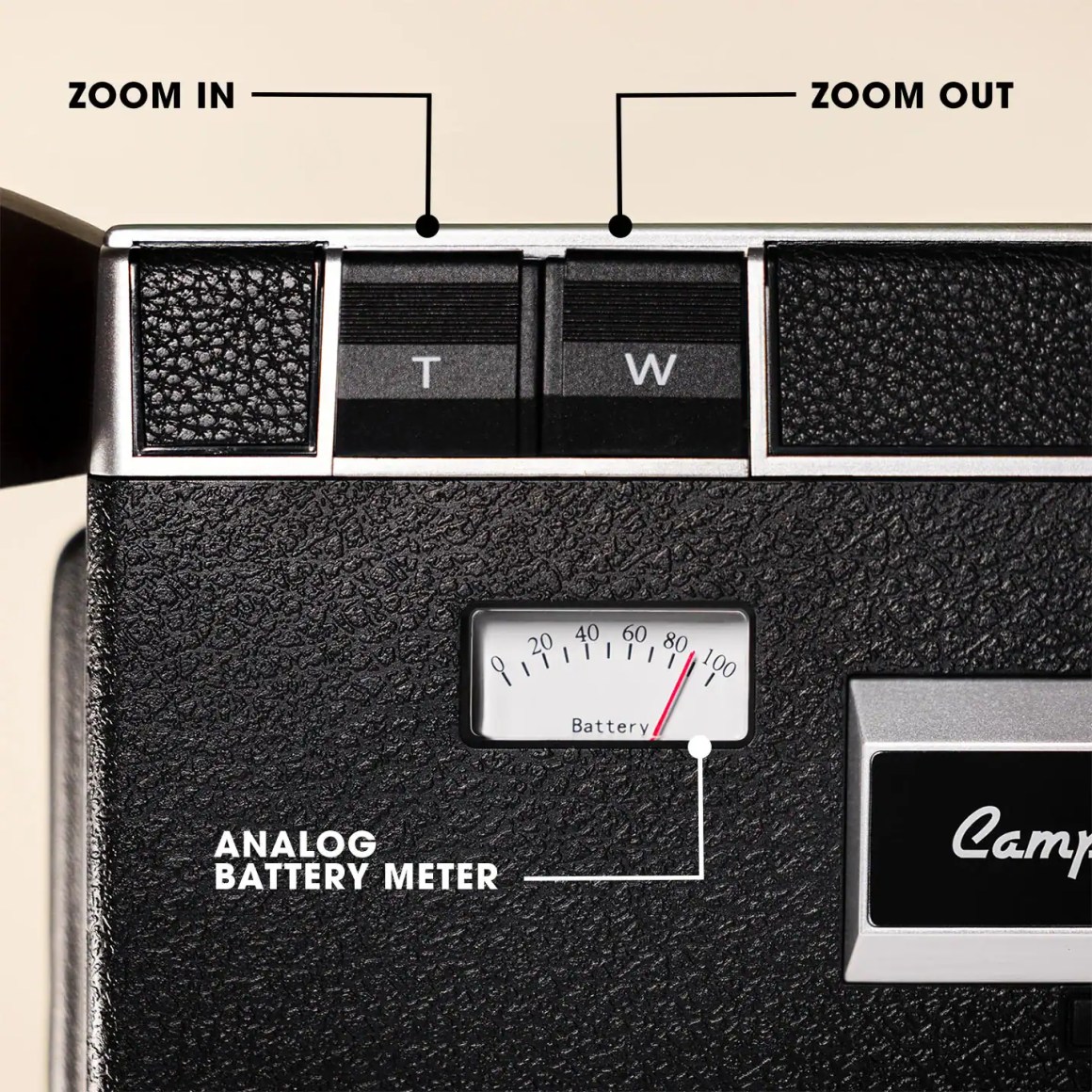 Close-up view of a camera showing the zoom controls and an analog battery meter.