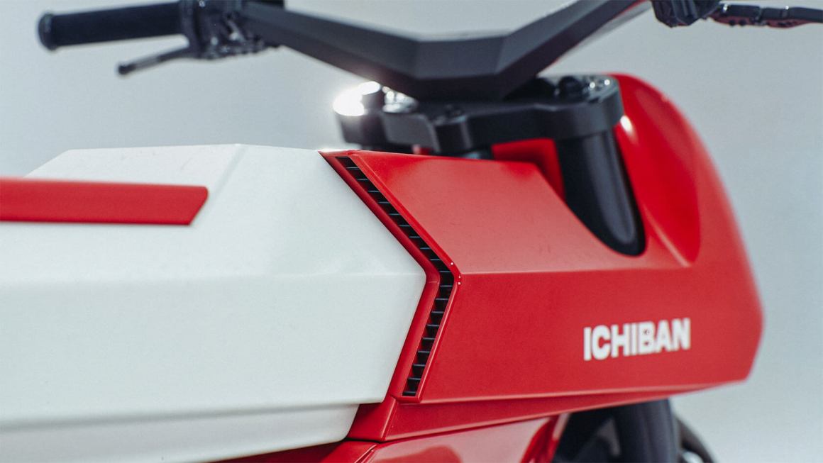 Close-up of a red and white motorcycle with the brand name 'ICHIBAN' displayed prominently.