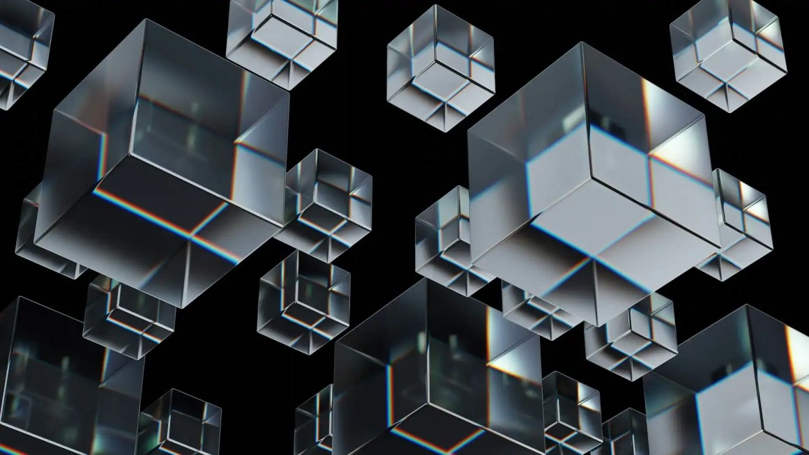 A cluster of transparent 3D cubes floating against a black background, reflecting light and casting subtle shadows.